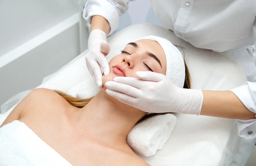 Dermatologist performing acne treatments on a relaxed patient.